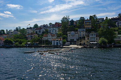 View of townscape by sea against sky