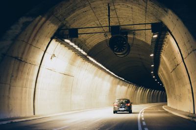 Car in illuminated tunnel