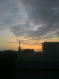 Built structure against cloudy sky at sunset