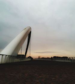 View of suspension bridge against cloudy sky