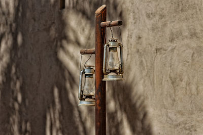 Close-up of old lanterns hanging on pole