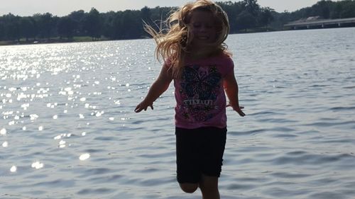 Full length of girl standing in water