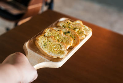 Close-up of person holding ice cream in plate