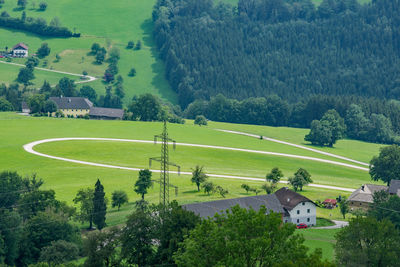 High angle view of trees and houses on field