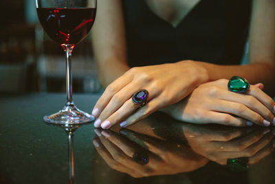 Midsection of woman having drink