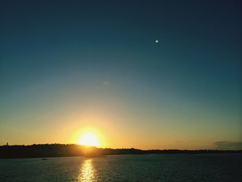 Scenic view of sea against clear sky during sunset