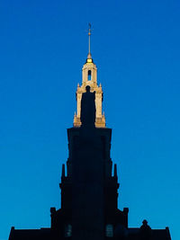 Low angle view of tower against clear blue sky