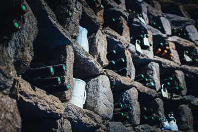 Full frame shot of wine bottles in stone wall