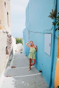 Woman standing by sea against sky