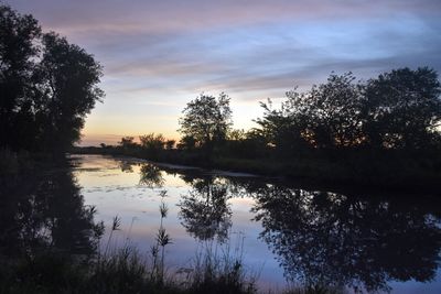 Scenic view of lake at sunset