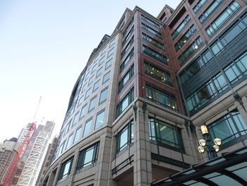 Low angle view of modern buildings against clear sky