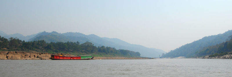 Scenic view of lake and mountains against clear sky