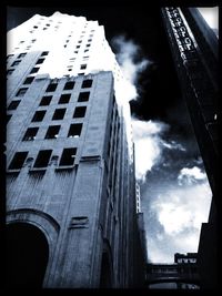 Low angle view of building against cloudy sky