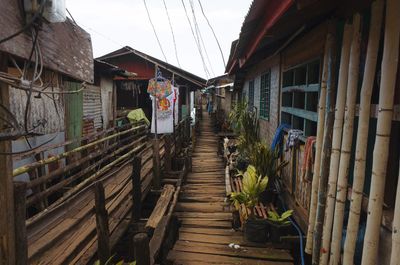 Boardwalk amidst buildings against sky