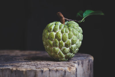 Close-up of custard apple on cutting board