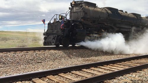 Train on railroad track against sky