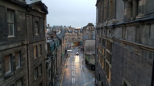 Street amidst buildings in city against sky