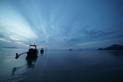 People on sea against sky