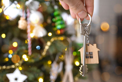 Cropped hand holding christmas decorations