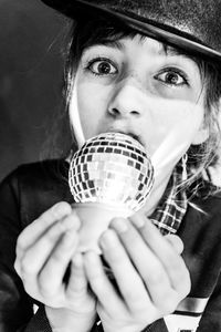 Portrait of girl holding disco ball 