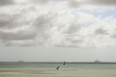 Scenic view of sea against cloudy sky