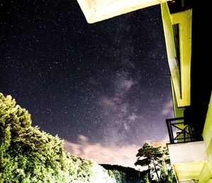 Low angle view of trees against sky at night