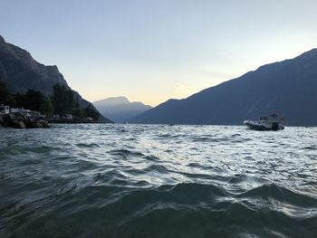 Scenic view of sea and mountains against sky