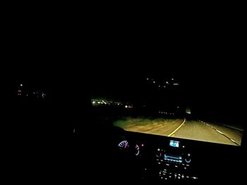 View of illuminated road at night