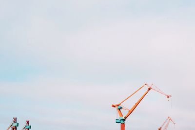 Low angle view of crane against sky