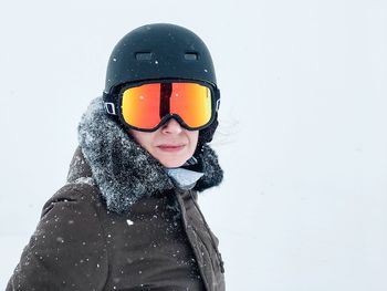 Portrait of smiling young woman in snow