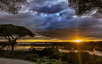 Scenic view of dramatic sky over landscape during sunset