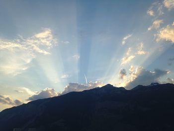 Scenic view of mountains against cloudy sky