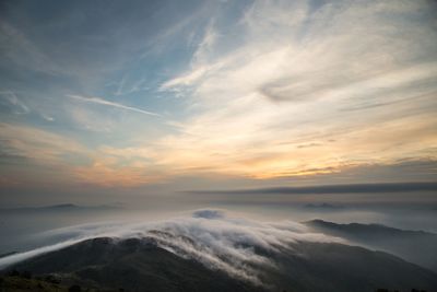 Scenic view of mountains against sky at sunset