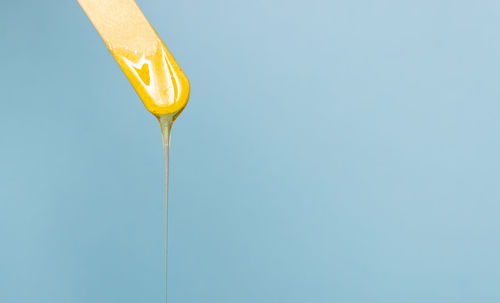 Close-up of drink against blue background