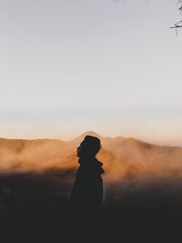 Side view of silhouette man standing on land