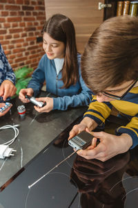Side view of woman using calculator