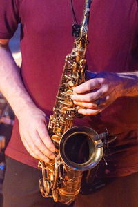 Midsection of man playing guitar