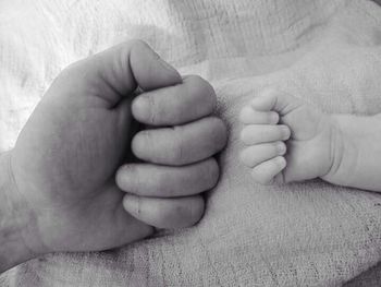 Close-up of baby hand holding baby