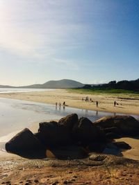 People on beach against sky