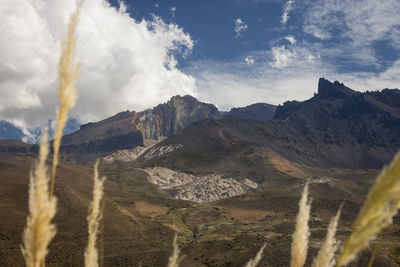 Scenic view of mountains against cloudy sky