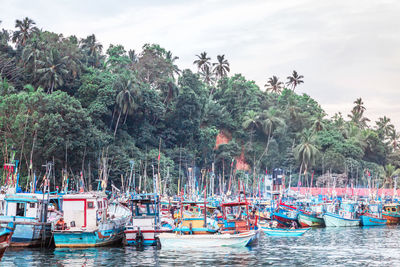 Boats moored in sea against sky