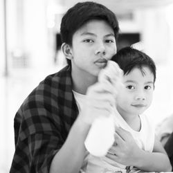 Portrait of sibling sitting at home