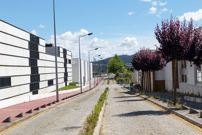 Street amidst buildings against sky