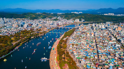 High angle view of crowd at harbor against buildings in city