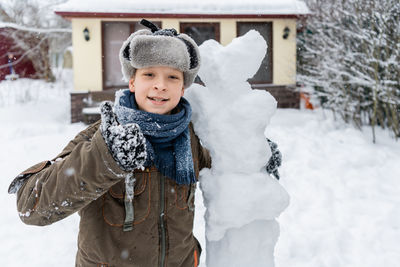 Portrait of boy with snowman