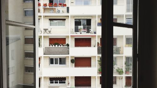 Residential building seen through glass window
