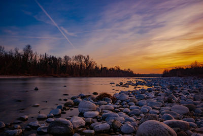 Scenic view of lake against sky during sunset