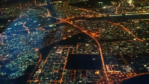 Aerial view of city lit up at night