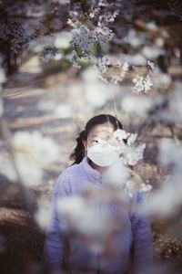 High angle view of girl wearing mask standing in park