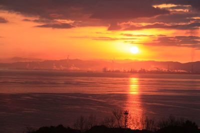 Scenic view of sea against romantic sky at sunset